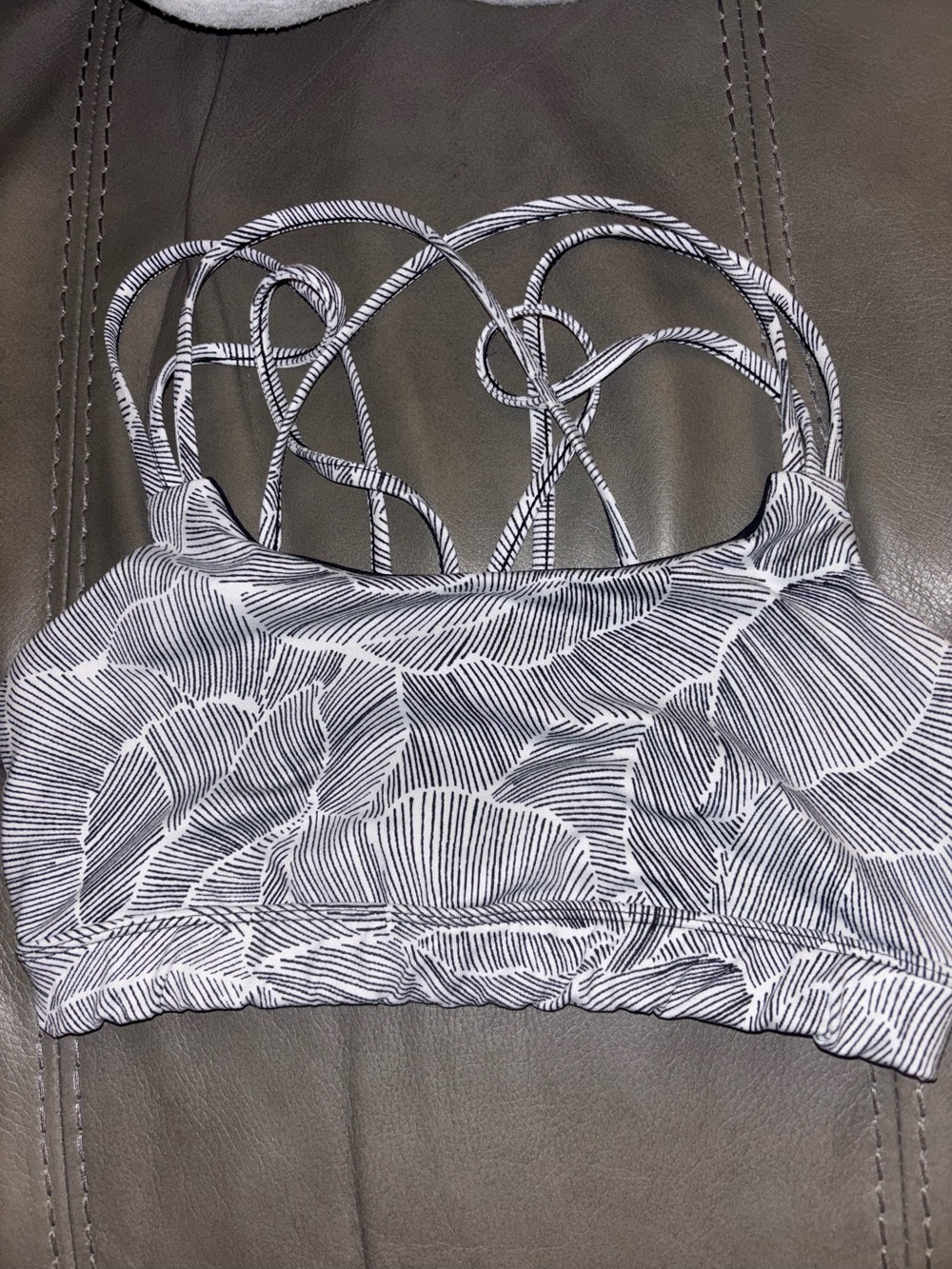 GapFit Eclipse Multi-Strap Sports Bra in a stylized black and white palm/banana